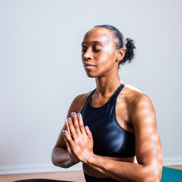 woman meditating with hands in payer