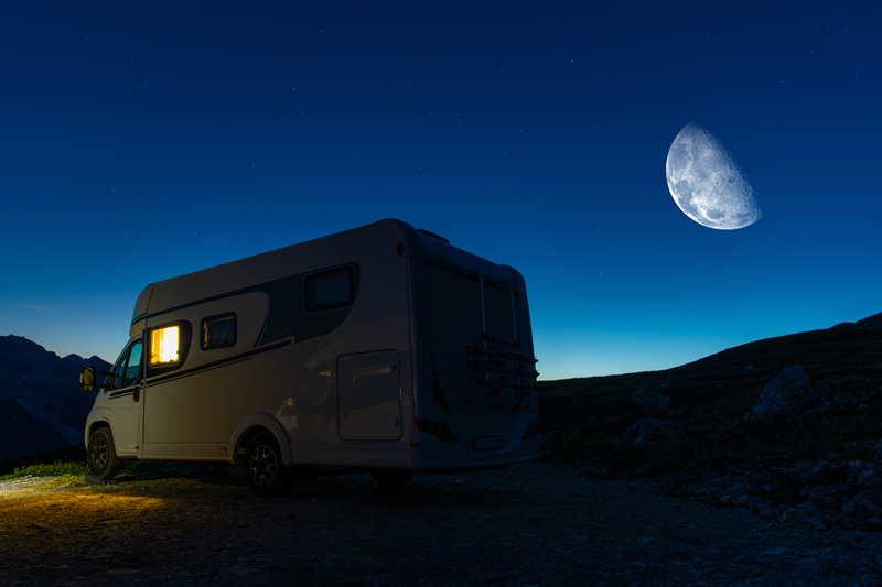 Camper Van and Clear Night Sky Over Camping Pitch