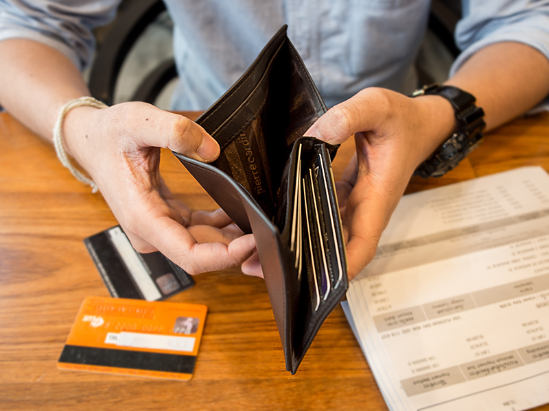 credit card debt - holding an empty wallet.